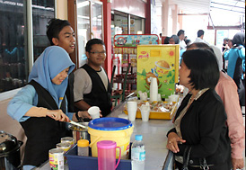 Tour of Malaysian high school co-op; members themselves provide services.