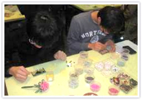 Participants decorate card holders in Korean art craft session